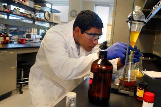 Researcher working with chemicals and lab equipment